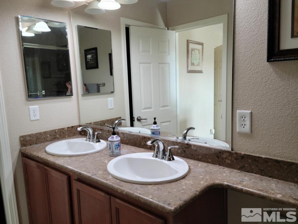 8950 Convair Way Reno, NV 89506 - Photo 12 of 26 a bathroom with a sink and a mirror