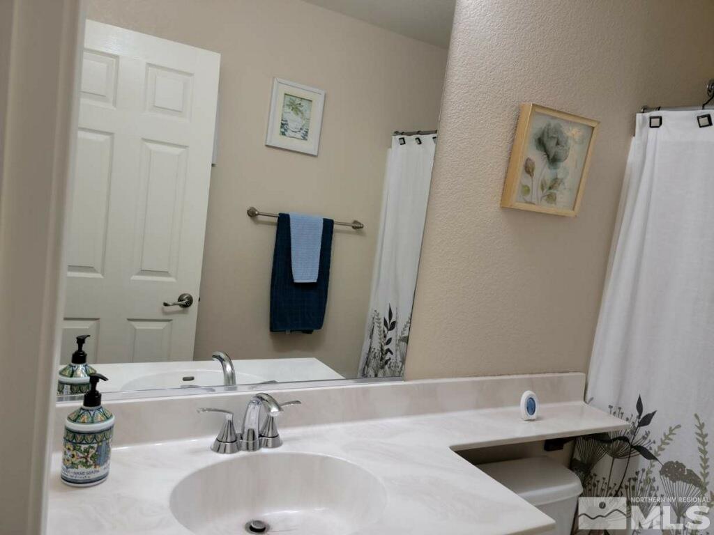 8950 Convair Way Reno, NV 89506 - Photo 16 of 26 a bathroom with a sink and a mirror