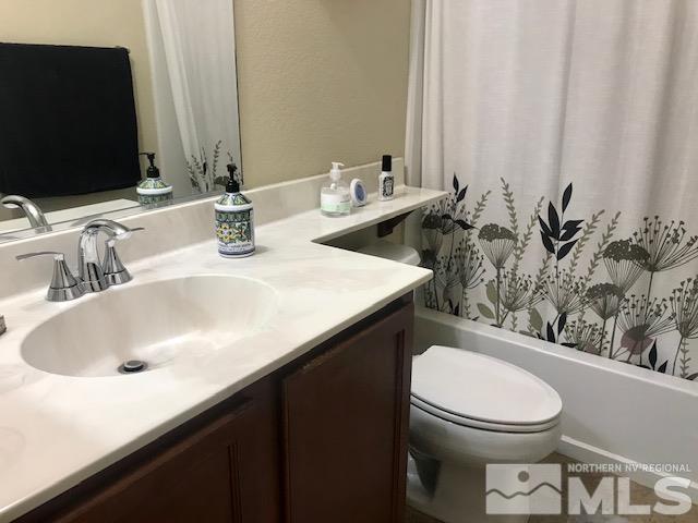 8950 Convair Way Reno, NV 89506 - Photo 17 of 26 a bathroom with a sink a toilet and a mirror