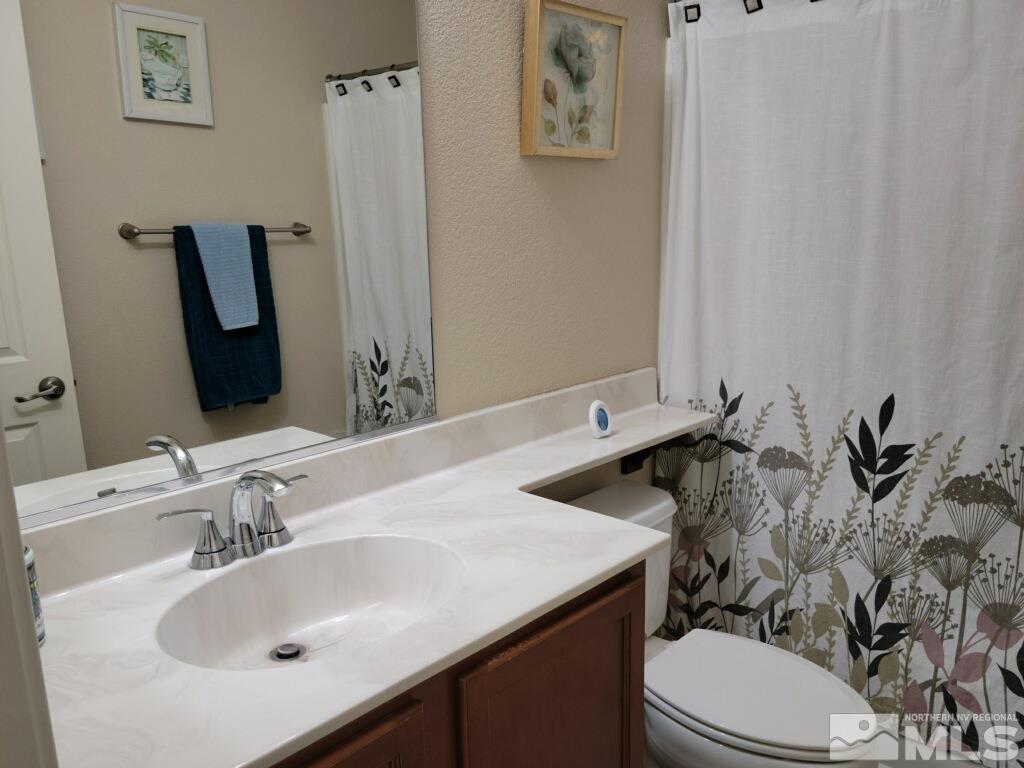8950 Convair Way Reno, NV 89506 - Photo 18 of 26 a bathroom with a sink toilet and mirror