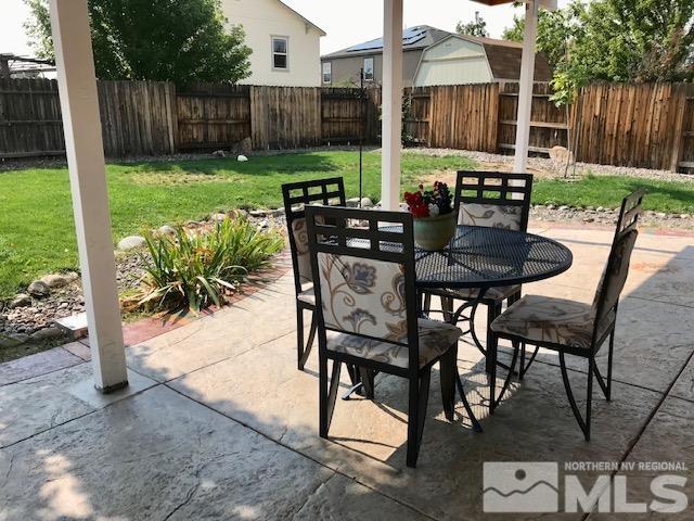 8950 Convair Way Reno, NV 89506 - Photo 20 of 26 a view of a patio with table and chairs and wooden fence