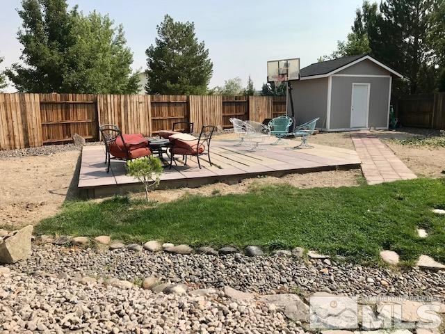 8950 Convair Way Reno, NV 89506 - Photo 22 of 26 a view of backyard of a house with wooden fence