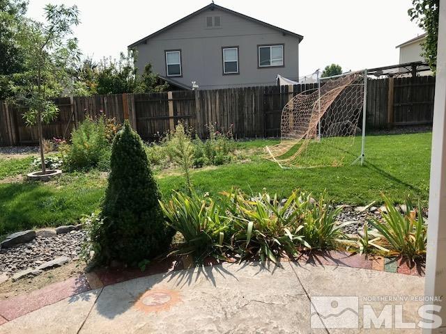 8950 Convair Way Reno, NV 89506 - Photo 23 of 26 a backyard of a house with potted plants and wooden fence