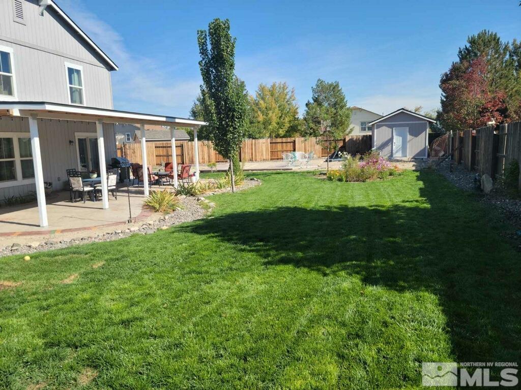 8950 Convair Way Reno, NV 89506 - Photo 24 of 26 a front view of a house with garden and porch