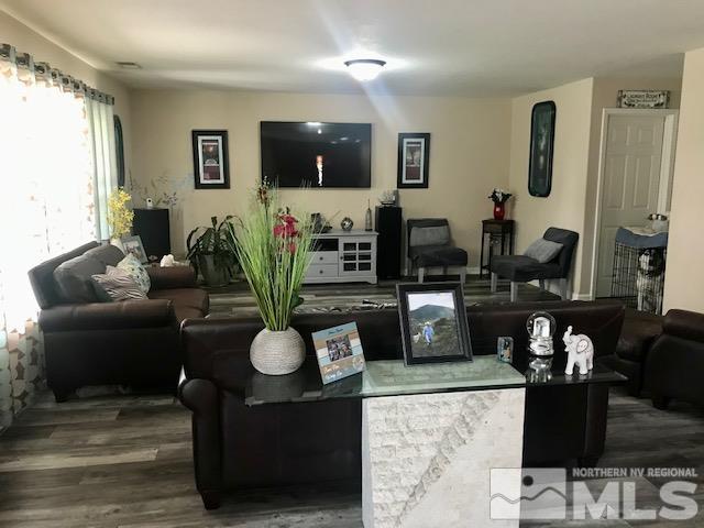 8950 Convair Way Reno, NV 89506 - Photo 3 of 26 a living room with furniture a flat screen tv and a large window