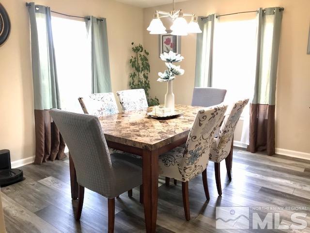 8950 Convair Way Reno, NV 89506 - Photo 4 of 26 a view of a dining room with furniture window and wooden floor