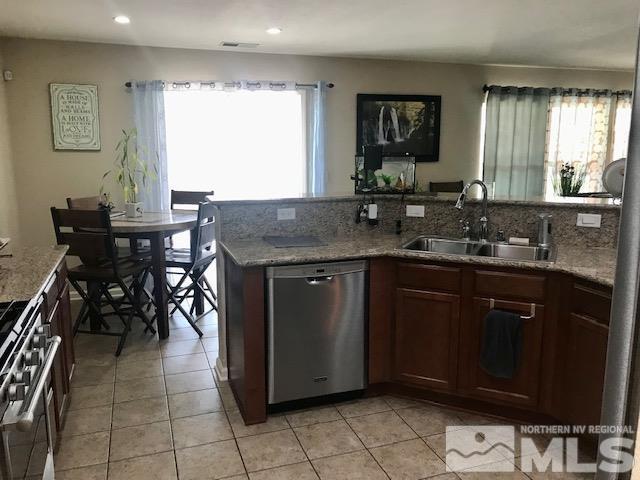 8950 Convair Way Reno, NV 89506 - Photo 5 of 26 a kitchen with a sink a table and chairs in it