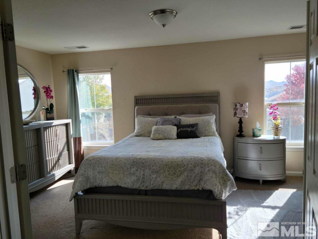 8950 Convair Way Reno, NV 89506 - Photo 8 of 26 a bedroom with a large bed and a window
