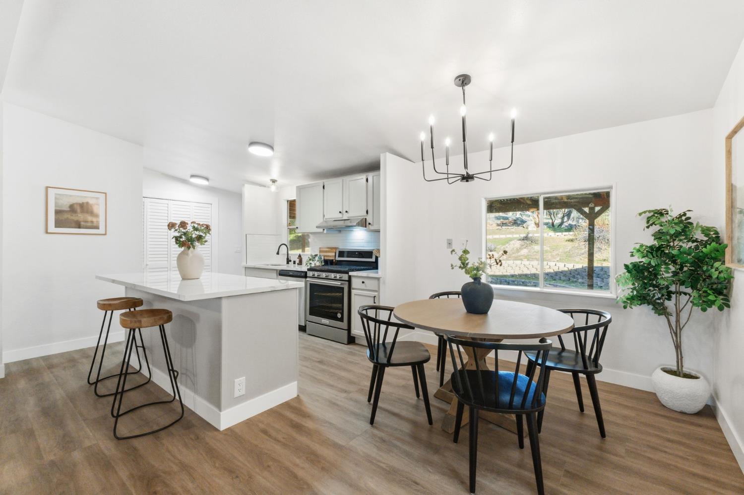 40089 John West Road Oakhurst, CA 93644 - Photo 14 of 59 a view of a dining room with furniture window and wooden floor
