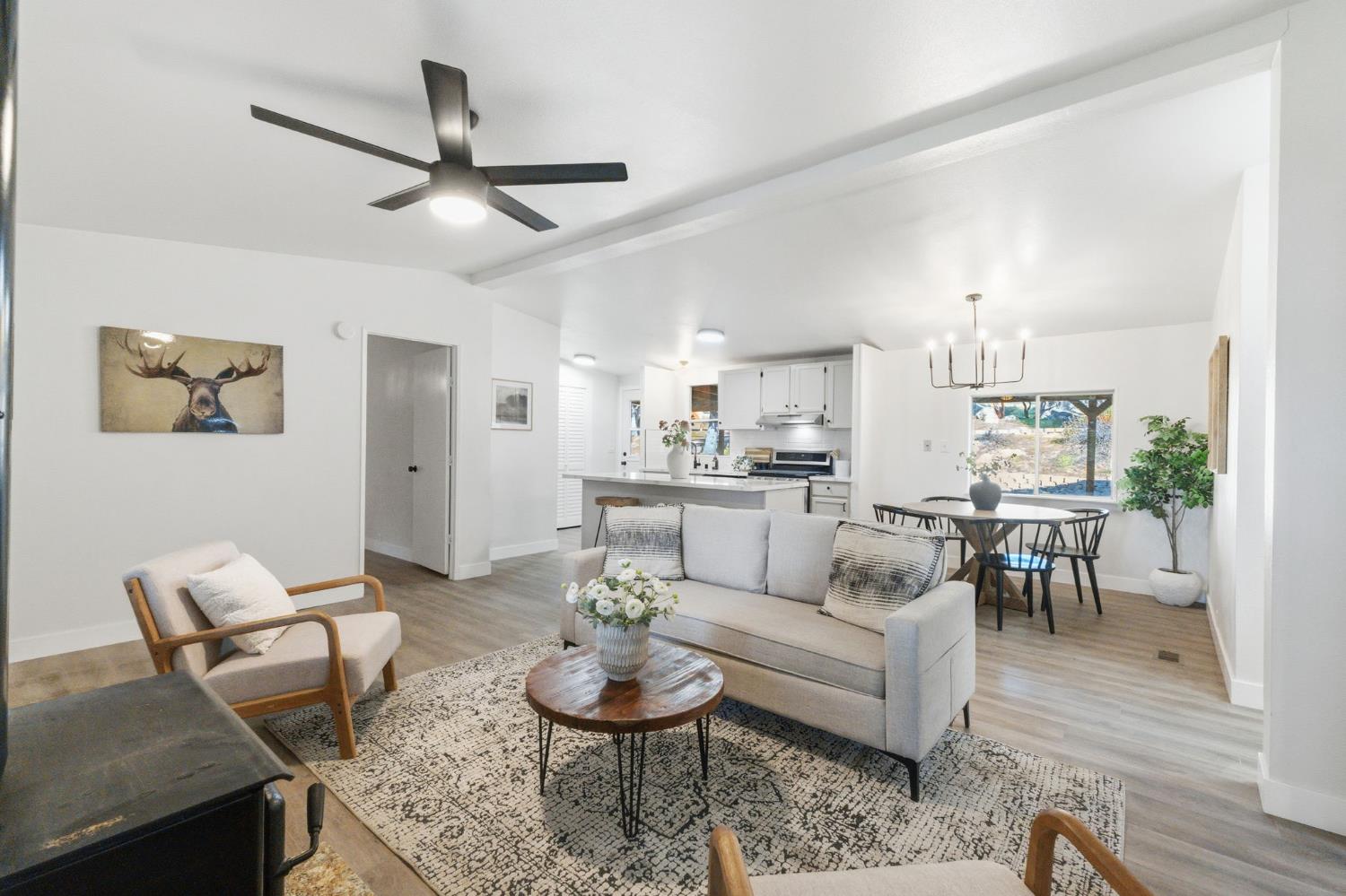 40089 John West Road Oakhurst, CA 93644 - Photo 15 of 59 a living room with furniture and a view of kitchen