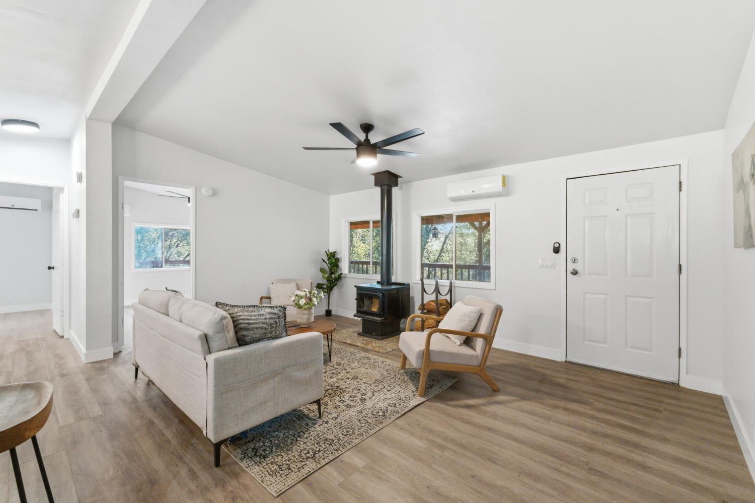 40089 John West Road Oakhurst, CA 93644 - Photo 16 of 59 a living room with furniture and a large window with wooden floor
