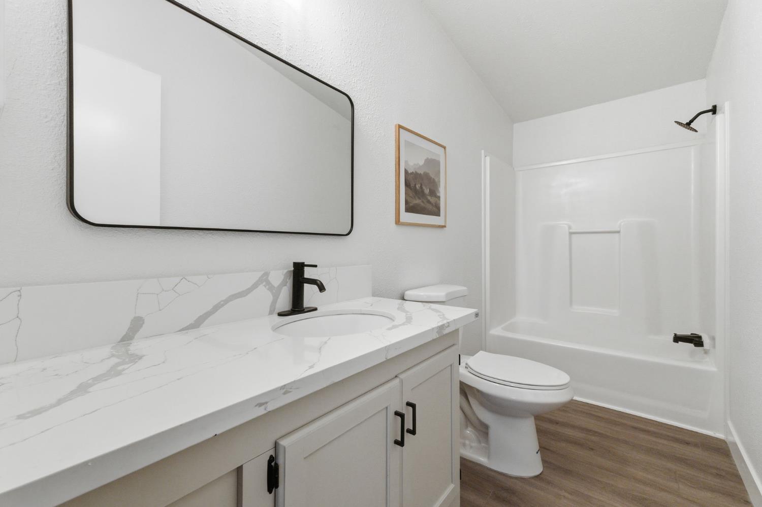 40089 John West Road Oakhurst, CA 93644 - Photo 25 of 59 a bathroom with a sink toilet and shower