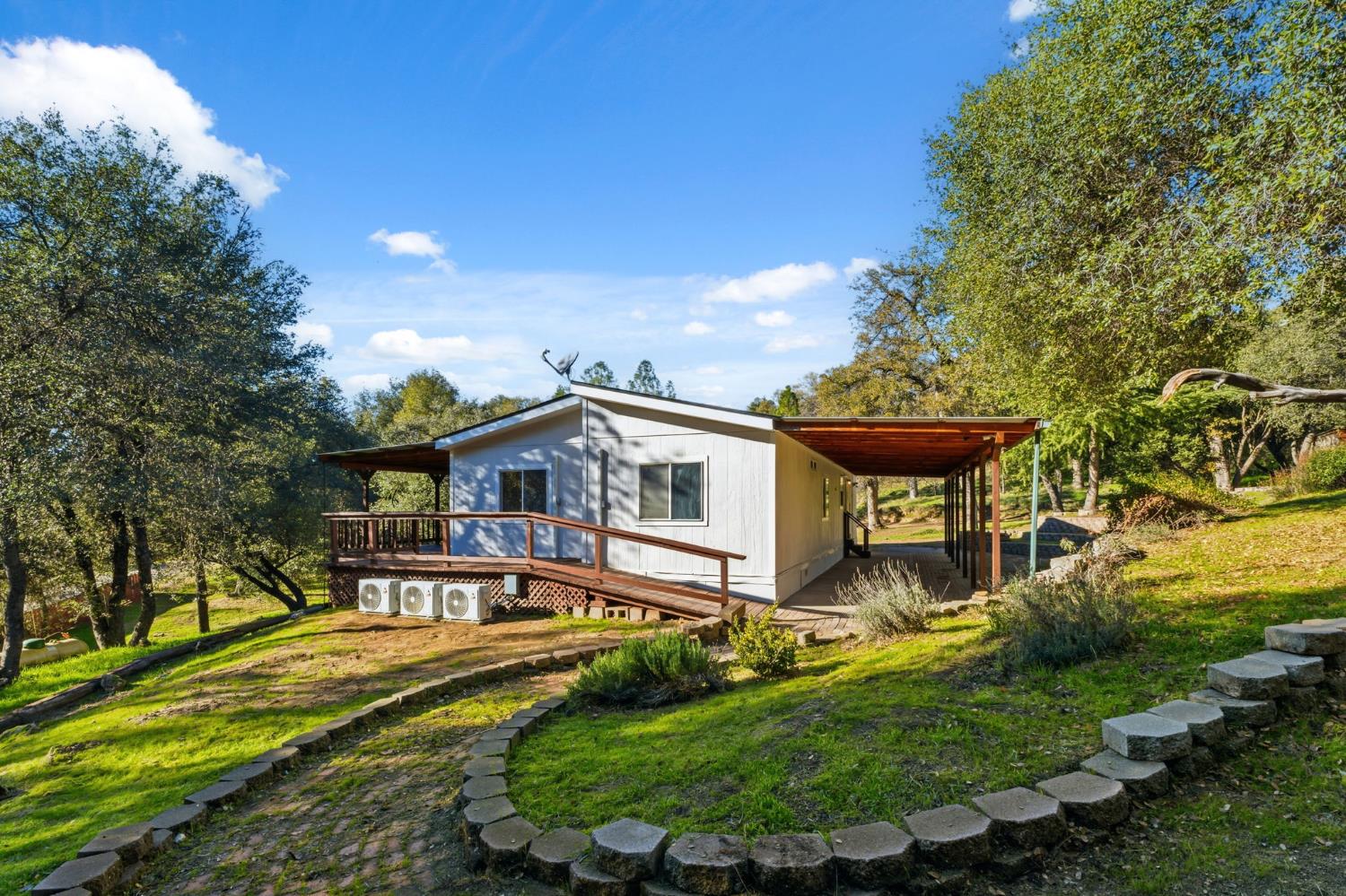40089 John West Road Oakhurst, CA 93644 - Photo 33 of 59 a front view of a house with a yard
