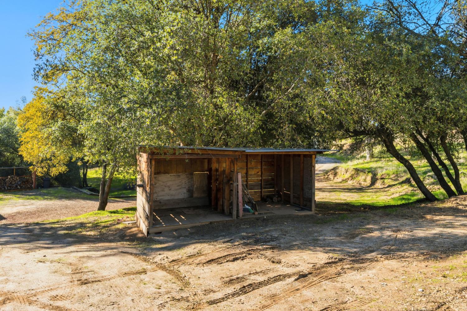 40089 John West Road Oakhurst, CA 93644 - Photo 41 of 59 a view of a house with a yard and garage