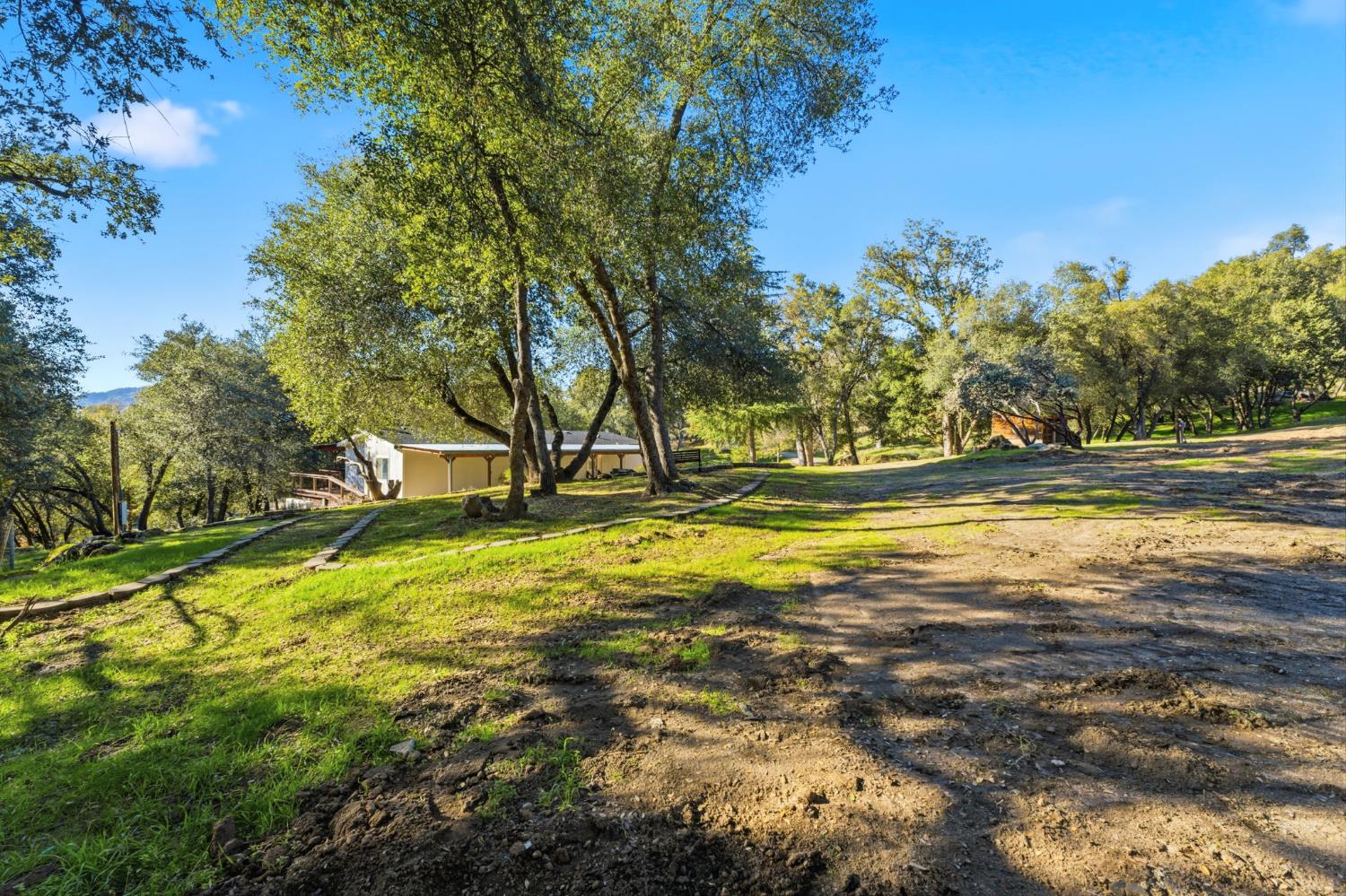 40089 John West Road Oakhurst, CA 93644 - Photo 44 of 59 a view of a swimming pool with an outdoor space and seating area