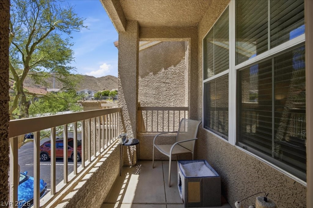 10550 West Alexander Road, Unit 2164 Las Vegas, NV 89129 - Photo 17 of 27 An inviting balcony offers serene mountain and neighborhood vistas, ideal for relaxation.