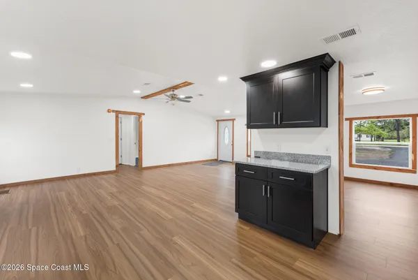 a large kitchen with stainless steel appliances granite countertop a stove and a sink