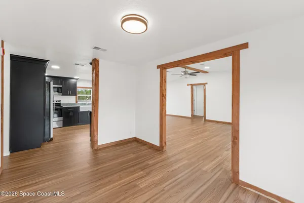 a view of hallway with wooden floor