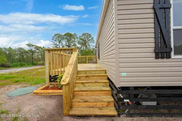 a view of a house with wooden deck