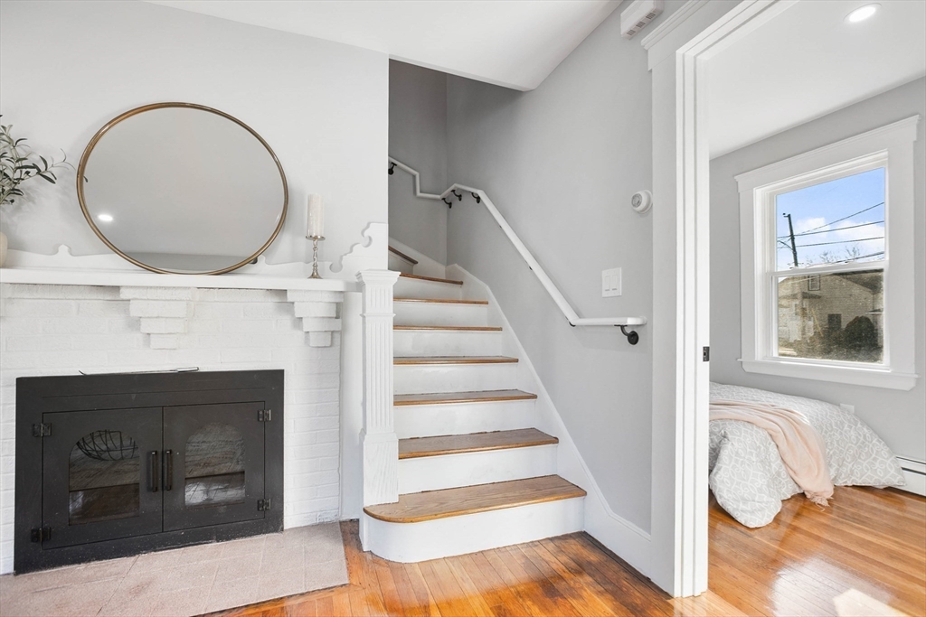 29 Lake View Place Lynn, MA 01904 - Photo 16 of 35 a view of a livingroom with wooden floor and a fireplace