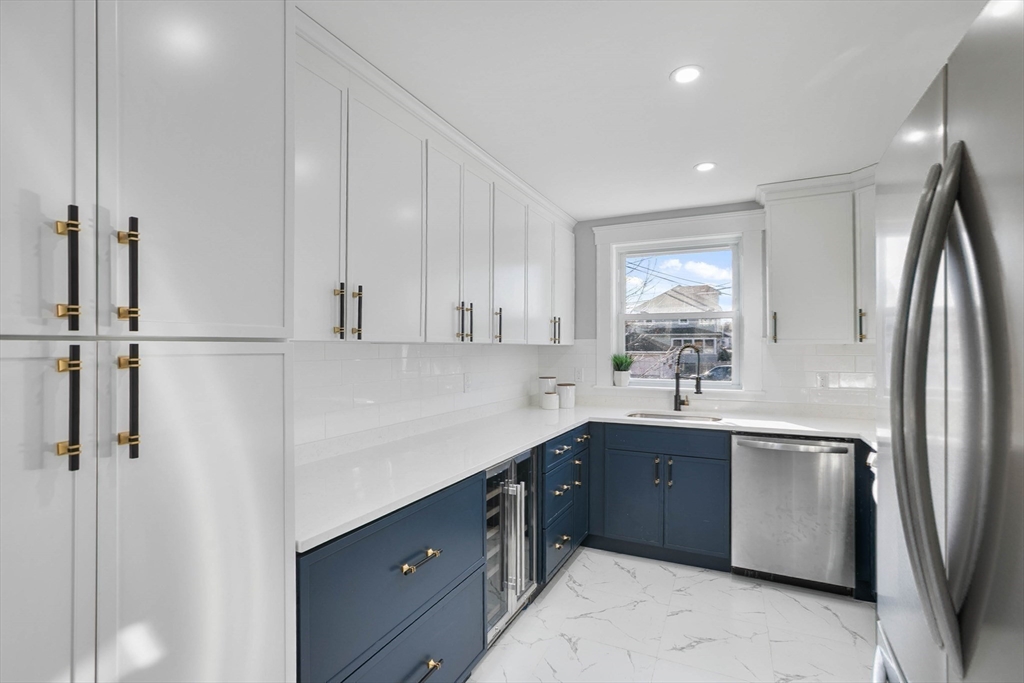 29 Lake View Place Lynn, MA 01904 - Photo 5 of 35 a kitchen with stainless steel appliances a sink stove and refrigerator