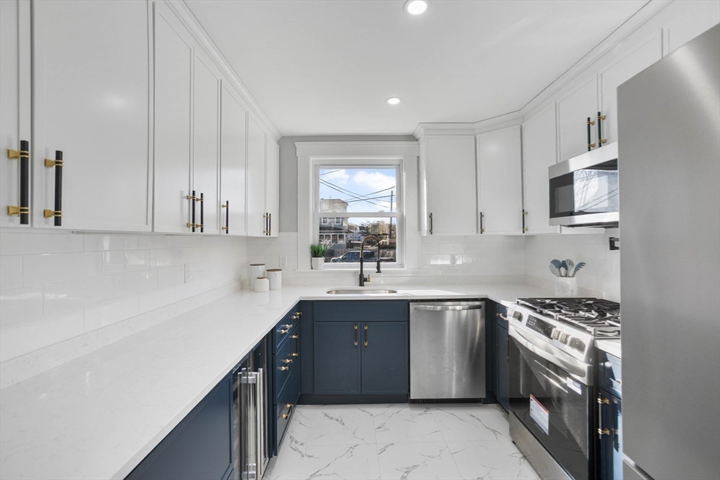 29 Lake View Place Lynn, MA 01904 - Photo 7 of 35 a kitchen that has a sink and a stove in it