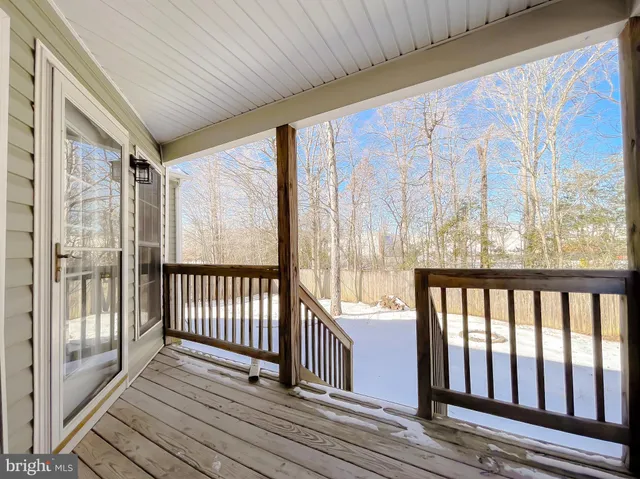 a view of hallway with wooden floor and door