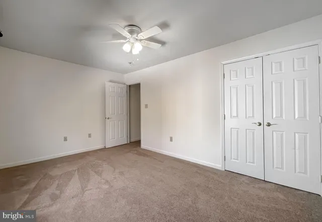 an empty room with closet and bathroom