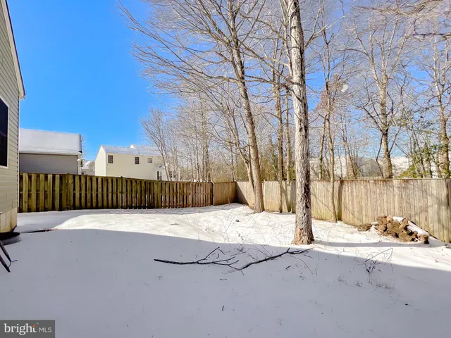 a view of a house with snow on the road