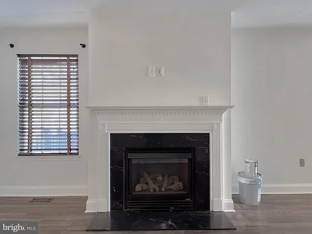 a living room with a fireplace and a fireplace