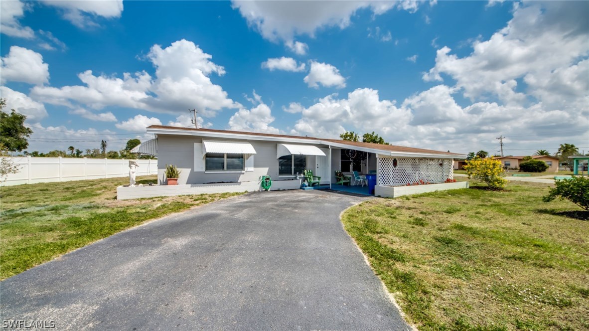 a front view of house with yard and entertaining space