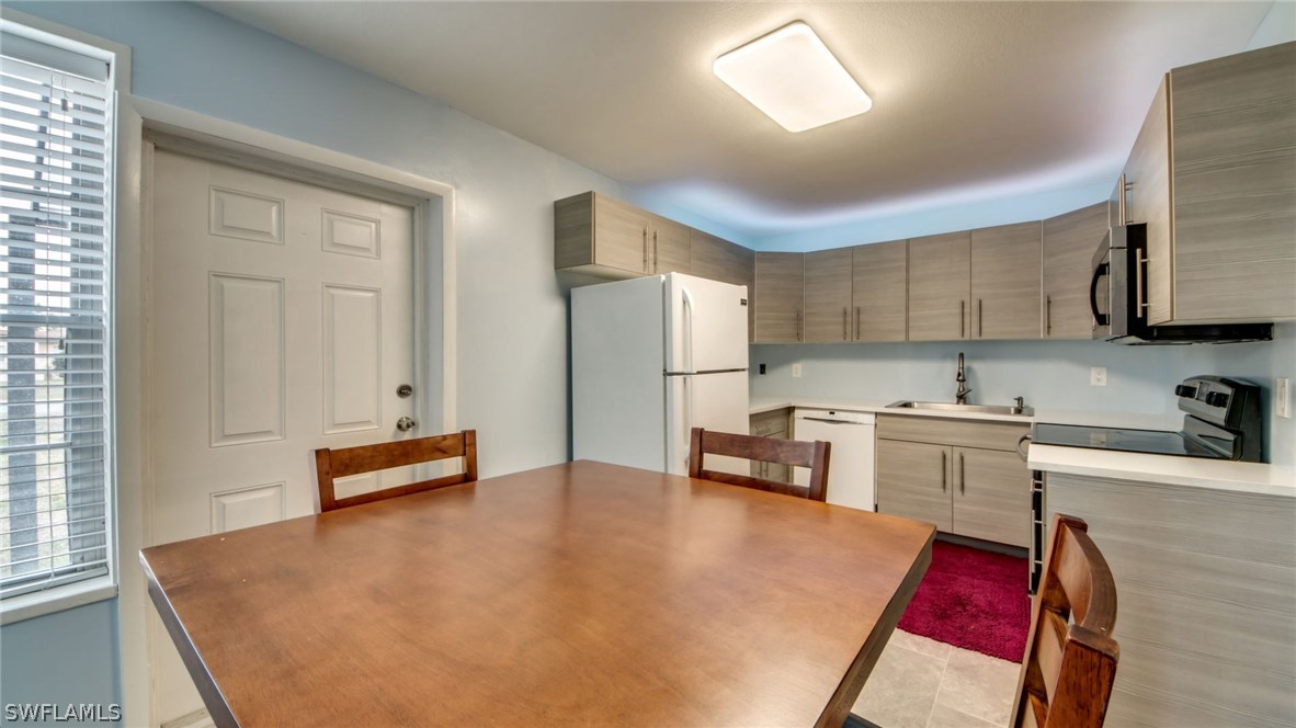 101 Oregon Road West Lehigh Acres, FL 33936 - Photo 15 of 24 a kitchen with stainless steel appliances granite countertop a refrigerator sink and stove