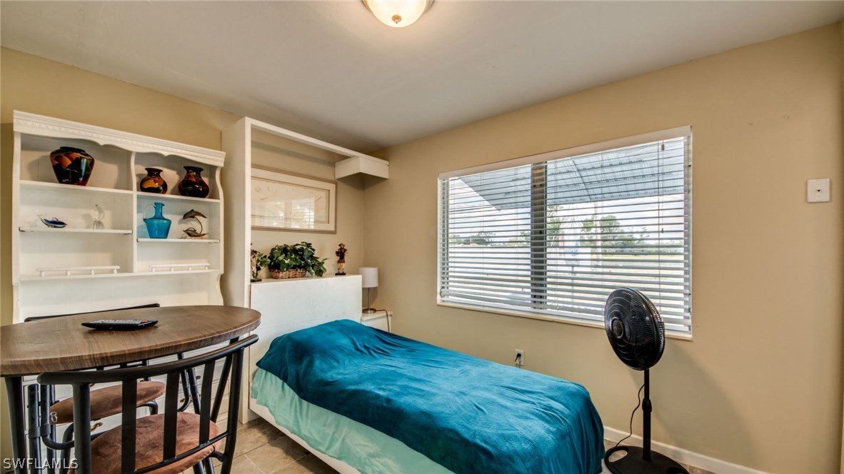 101 Oregon Road West Lehigh Acres, FL 33936 - Photo 20 of 24 a bedroom with a bed and a window