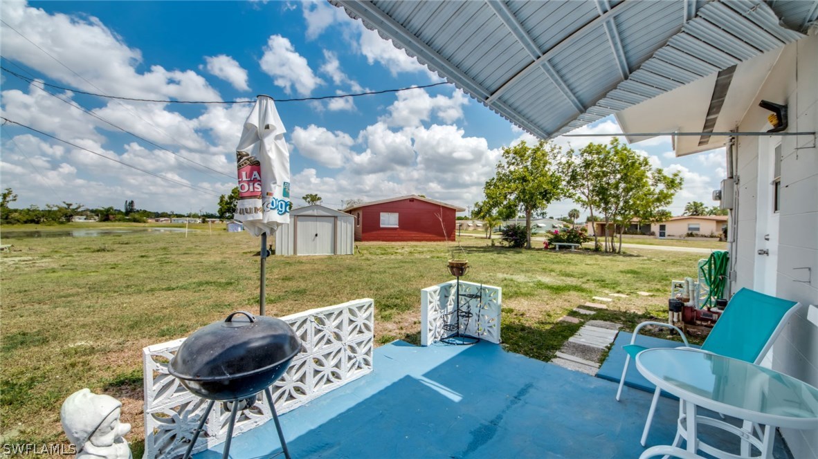 101 Oregon Road West Lehigh Acres, FL 33936 - Photo 4 of 24 a view of a table and chairs in the patio next to a yard