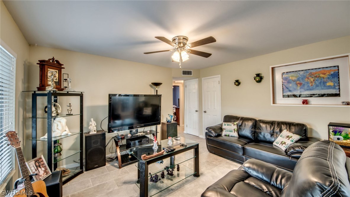 101 Oregon Road West Lehigh Acres, FL 33936 - Photo 7 of 24 a living room with furniture and a flat screen tv