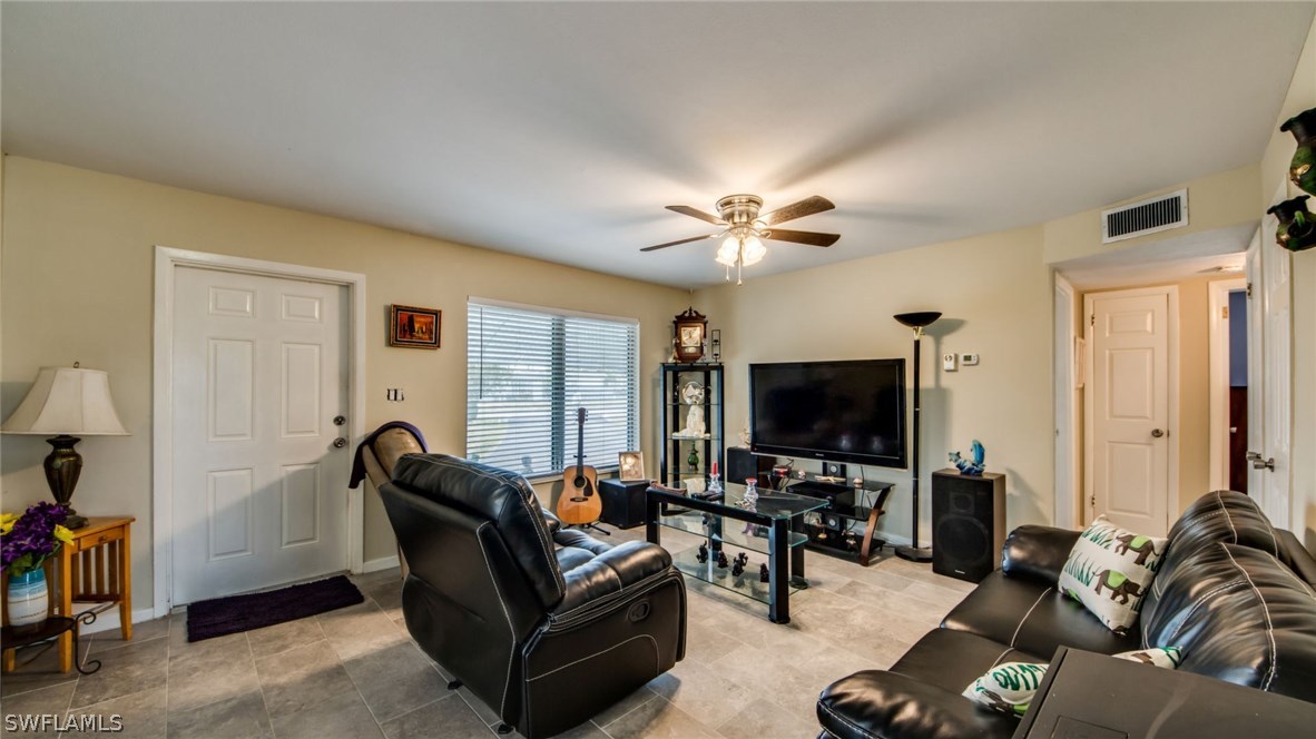 101 Oregon Road West Lehigh Acres, FL 33936 - Photo 8 of 24 a living room with furniture and a flat screen tv