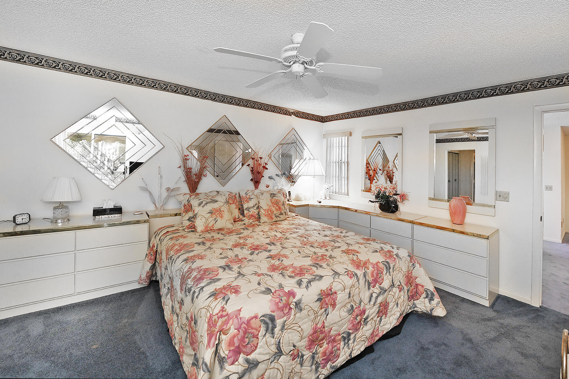 5135 Pointe Alexis Boca Raton, FL 33431 - Photo 22 of 35 a bed room with a bed and a chandelier