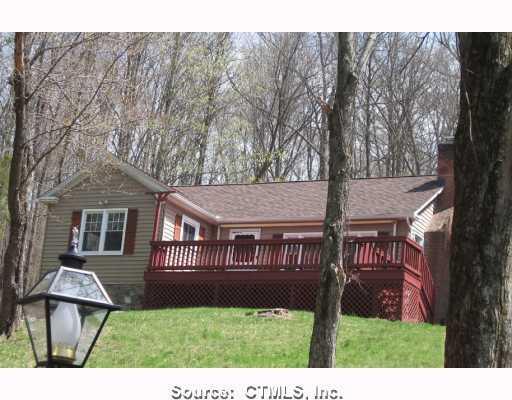 a view of house with a yard