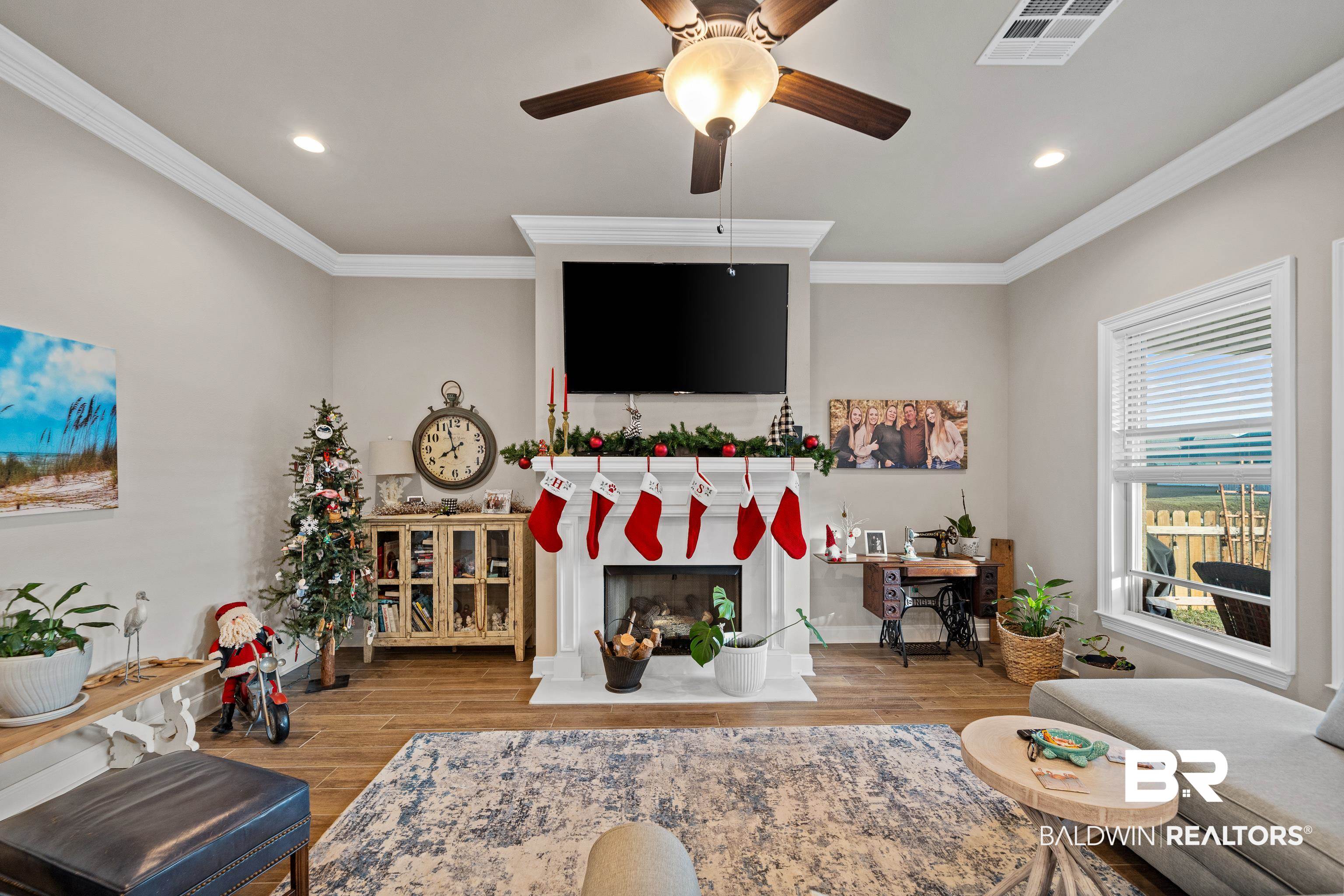 1390 Aldon Street Foley, AL 36535 - Photo 8 of 31 Living area featuring a ceiling fan, crown molding, recessed lighting, wood finished floors, and a fireplace