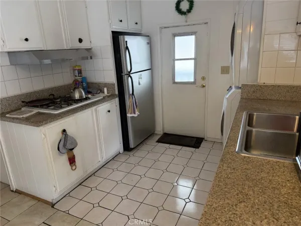 a utility room with sink dryer and washer