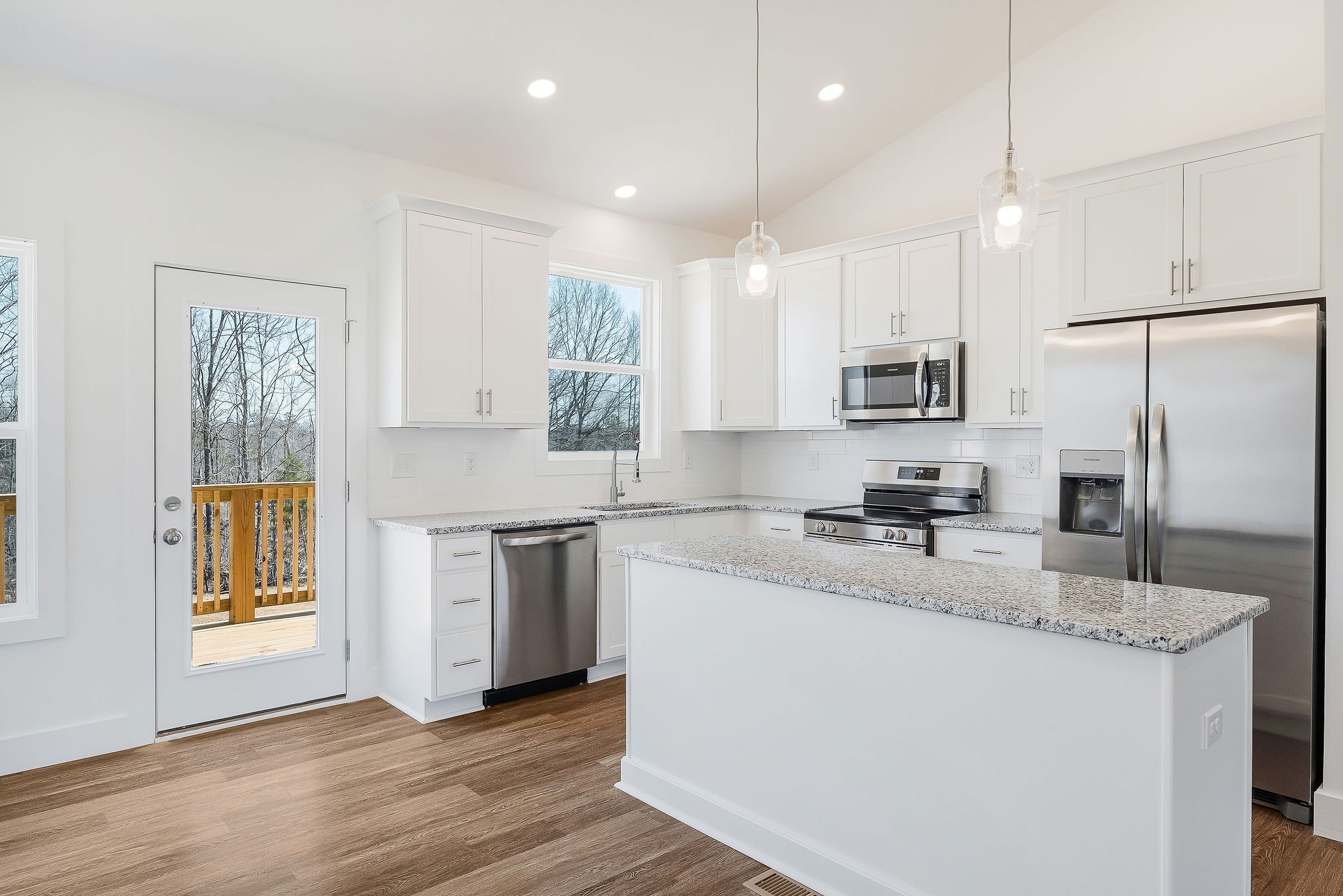 194 Johnson Chapel Road Sparta, TN 38583 - Photo 12 of 35 a kitchen with kitchen island granite countertop a sink appliances cabinets and a counter top space