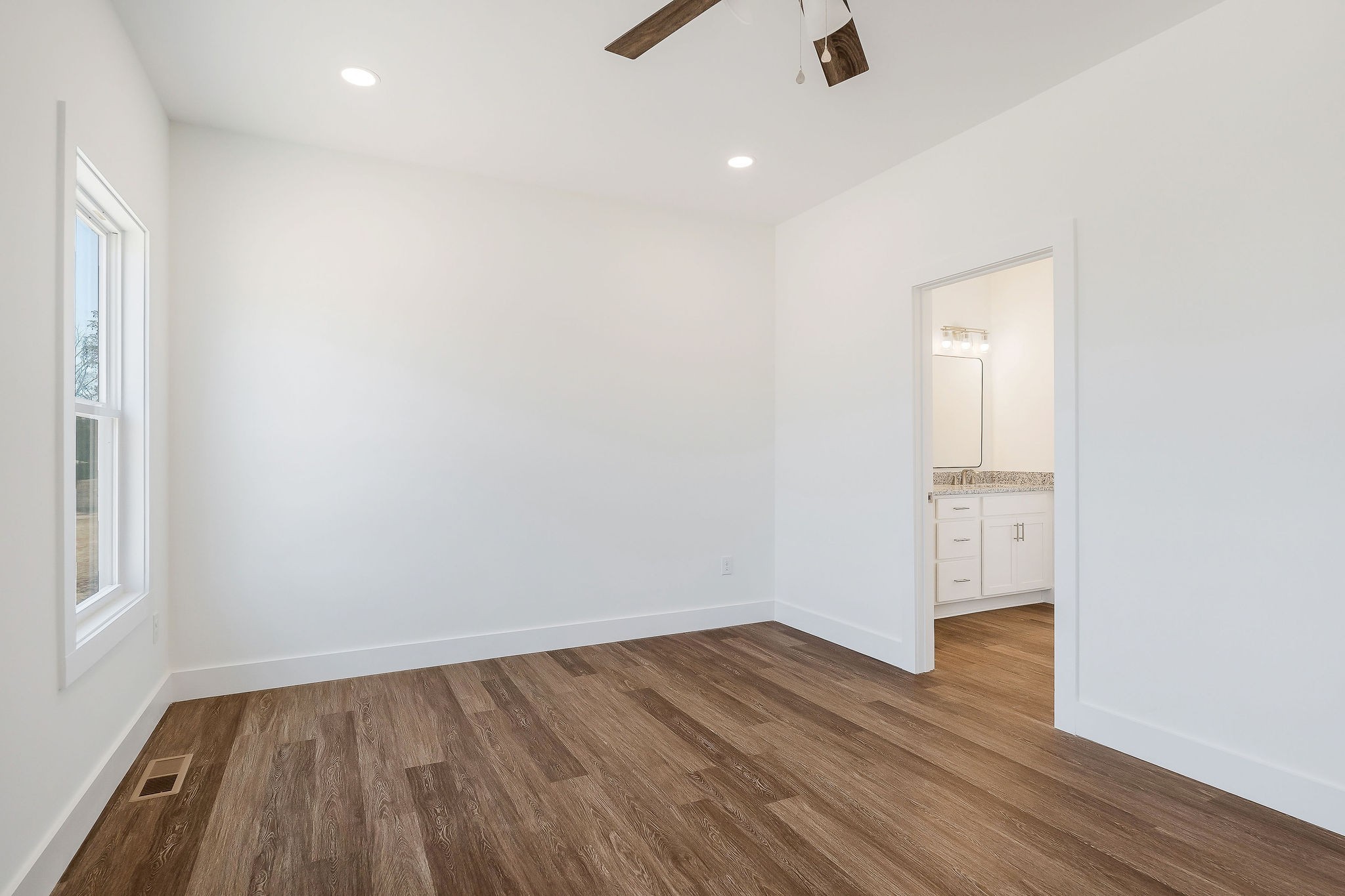 194 Johnson Chapel Road Sparta, TN 38583 - Photo 20 of 35 an empty room with wooden floor and windows