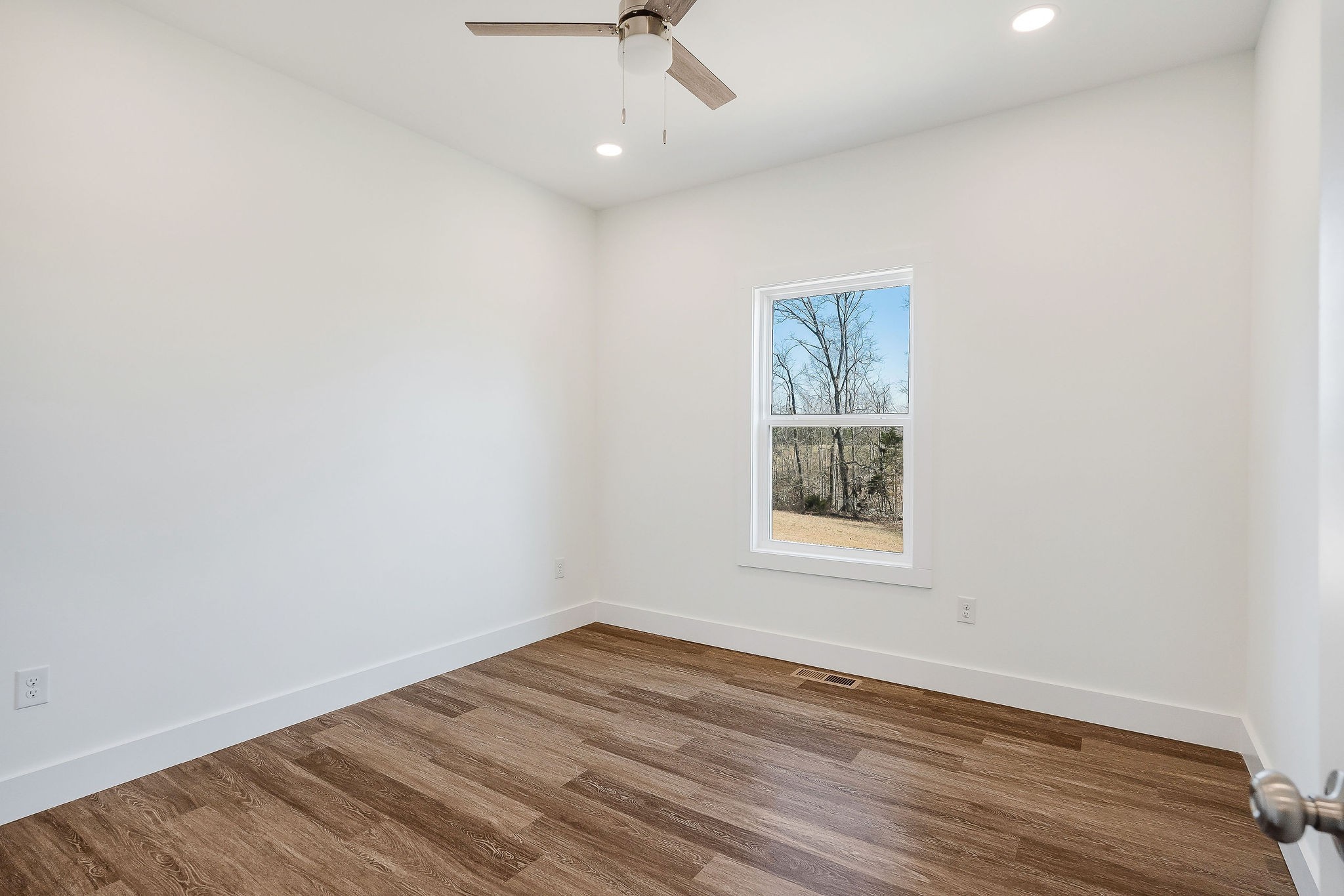 194 Johnson Chapel Road Sparta, TN 38583 - Photo 29 of 35 an empty room with a window and wooden floor