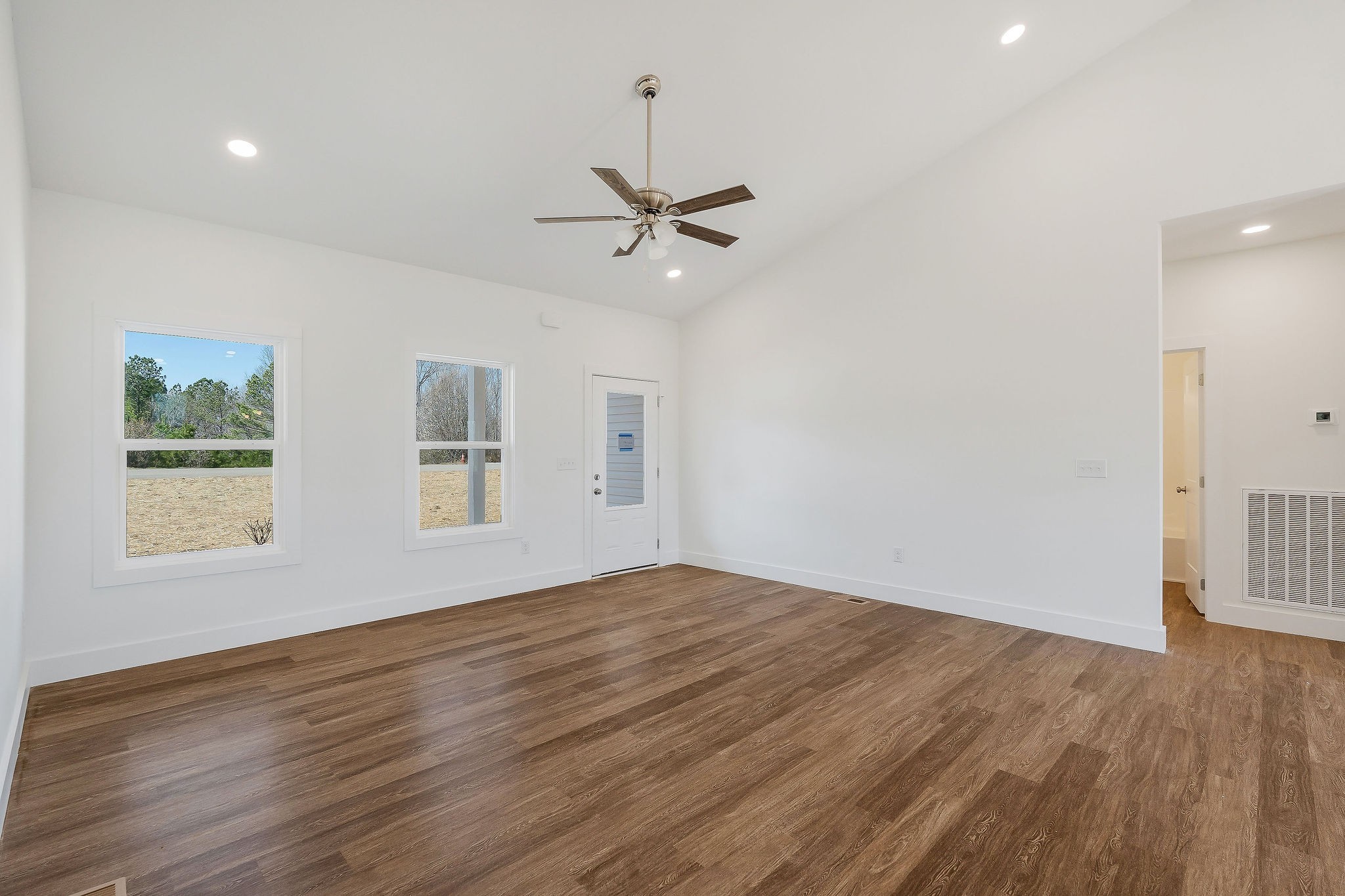 194 Johnson Chapel Road Sparta, TN 38583 - Photo 10 of 35 an empty room with wooden floor ceiling fan and windows