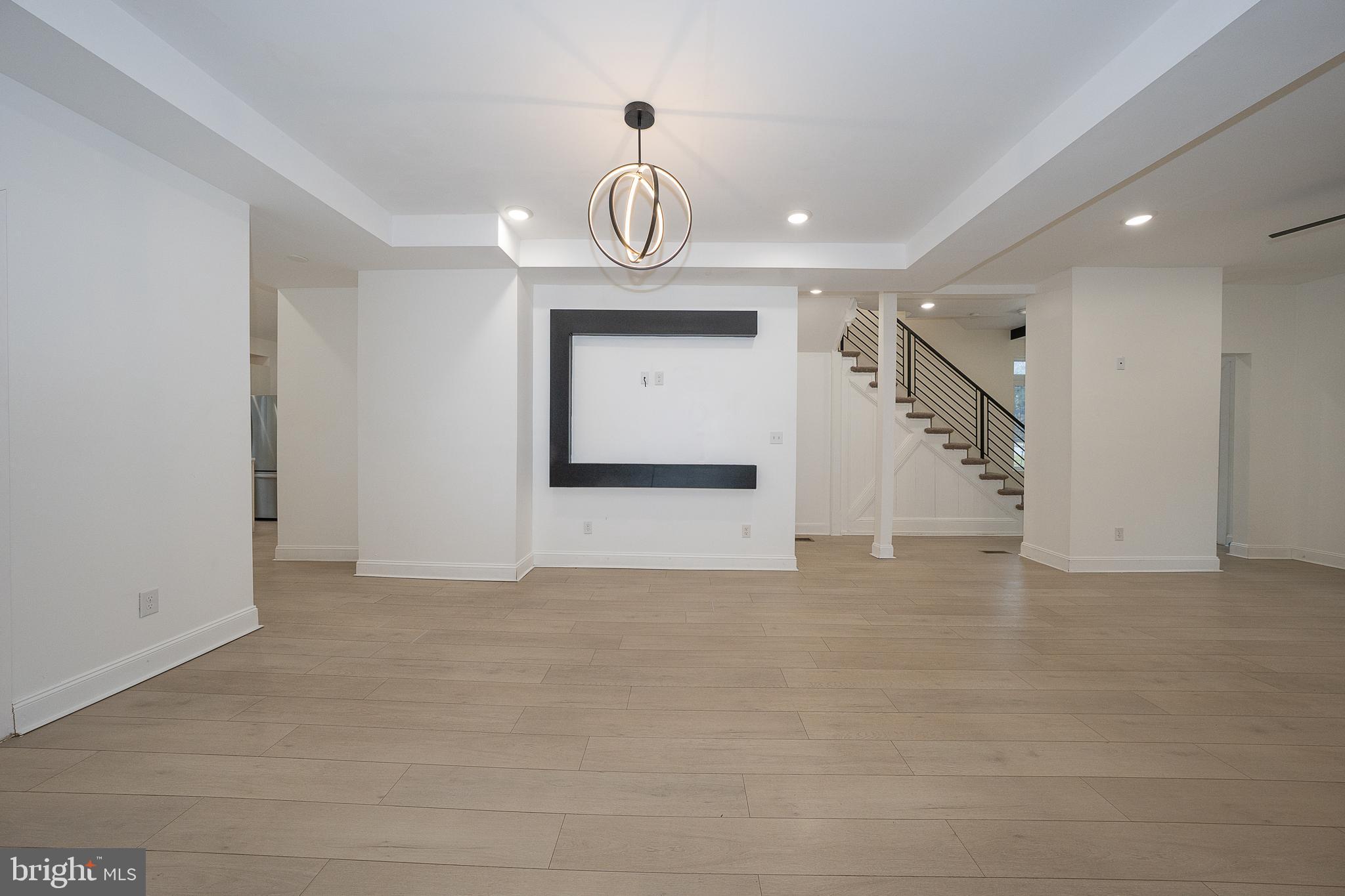 622 Spring Avenue Elkins Park, PA 19027 - Photo 13 of 65 a view of an empty room with wooden floor and windows