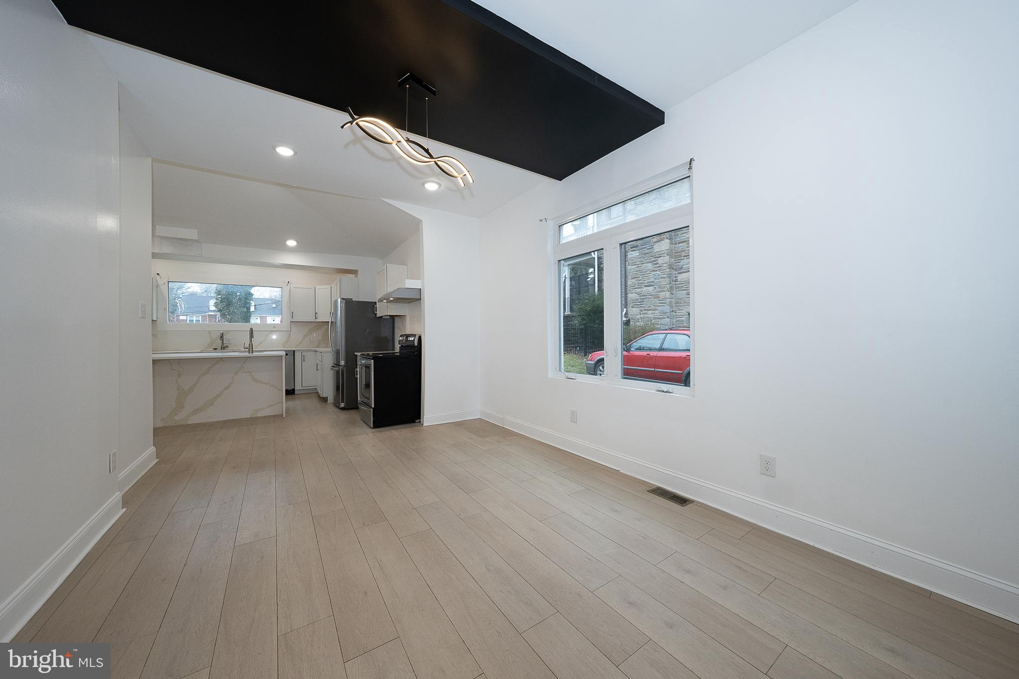622 Spring Avenue Elkins Park, PA 19027 - Photo 18 of 65 an empty room with wooden floor painted walls and windows
