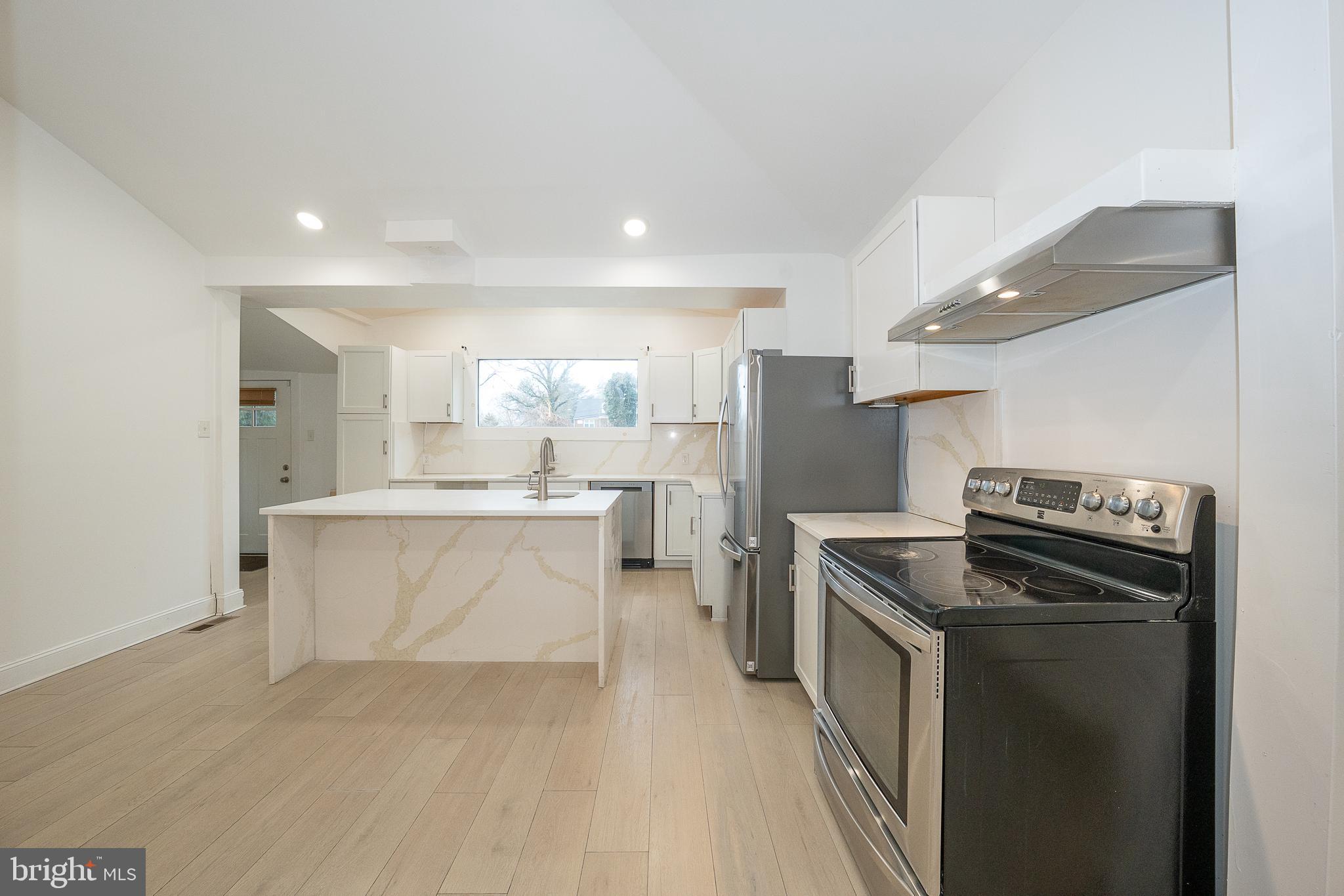622 Spring Avenue Elkins Park, PA 19027 - Photo 21 of 65 a kitchen with stainless steel appliances a stove a sink and a refrigerator