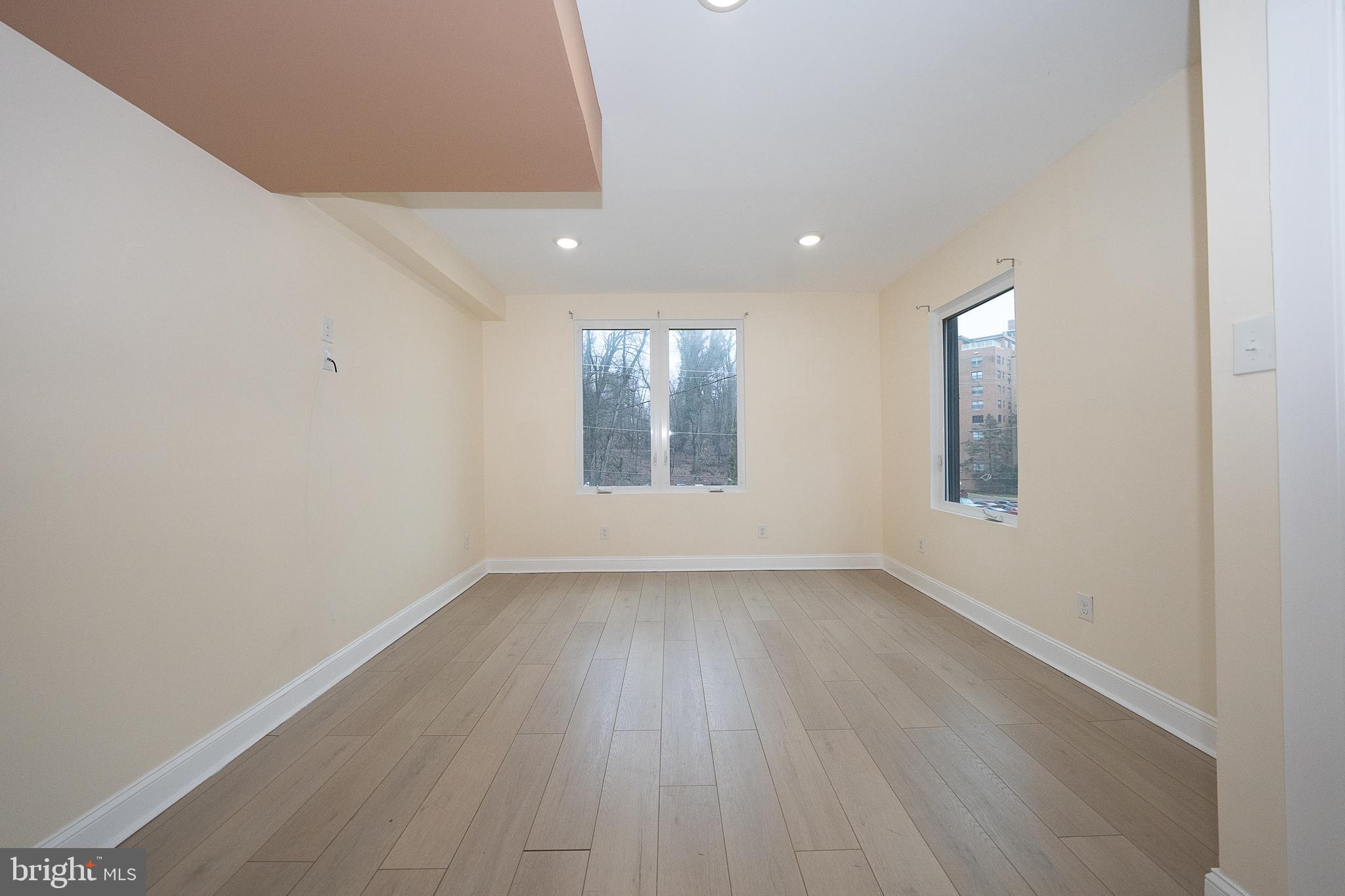 622 Spring Avenue Elkins Park, PA 19027 - Photo 32 of 65 an empty room with wooden floor and windows
