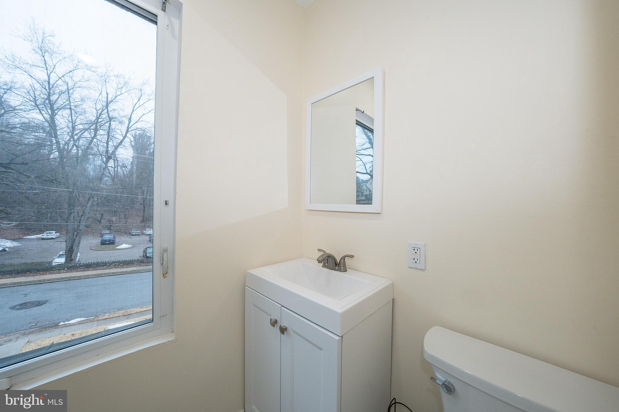 622 Spring Avenue Elkins Park, PA 19027 - Photo 42 of 65 a bathroom with a toilet sink and mirror