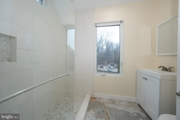 a bathroom with a toilet a sink and mirror